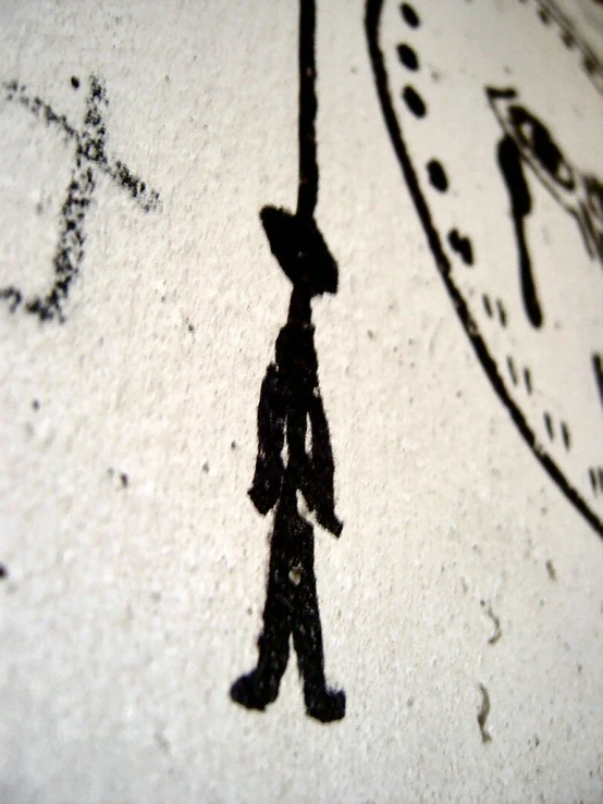 a person walks in front of a clock with a man shadow