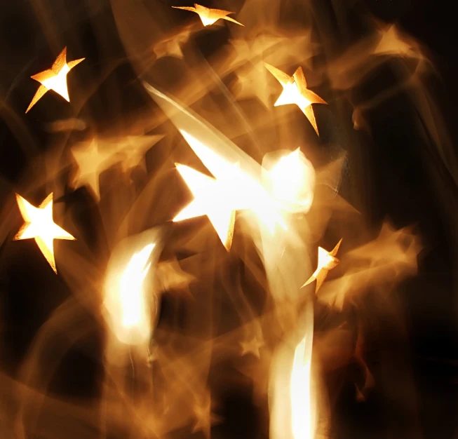 the gold stars are shining against a black background