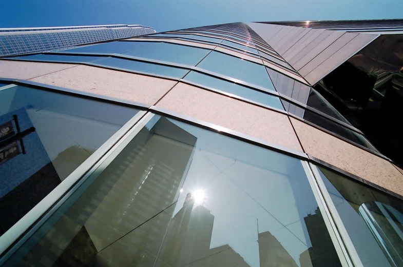 a tall building with an outside mirror on the glass