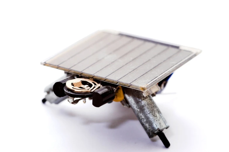 a white background with a black and yellow metal object