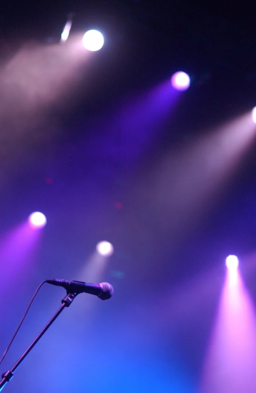 a microphone with purple and white lights above it