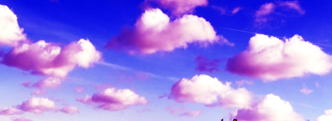 four boats that are in the water with clouds