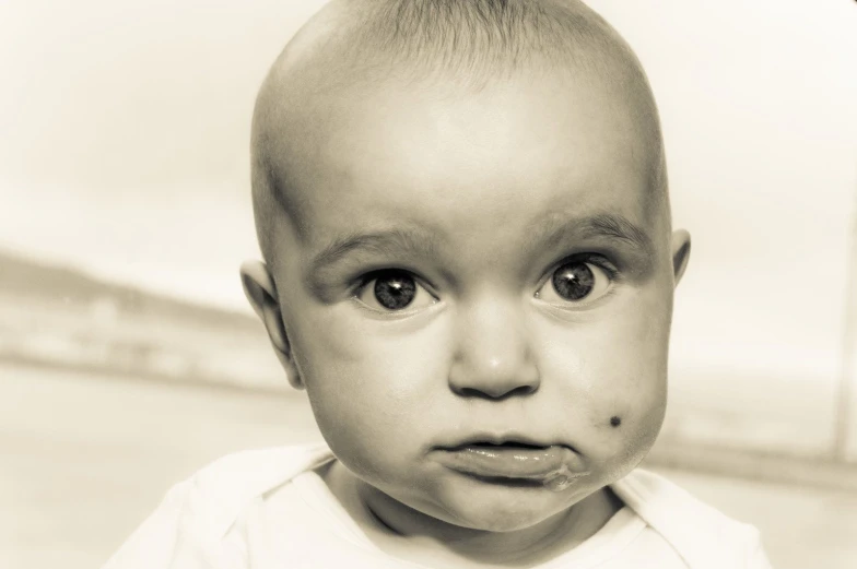 a bald child with a messy head and shaved hair