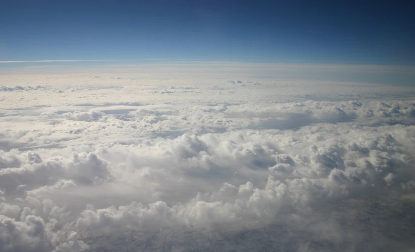 the sky with white fluffy clouds below it