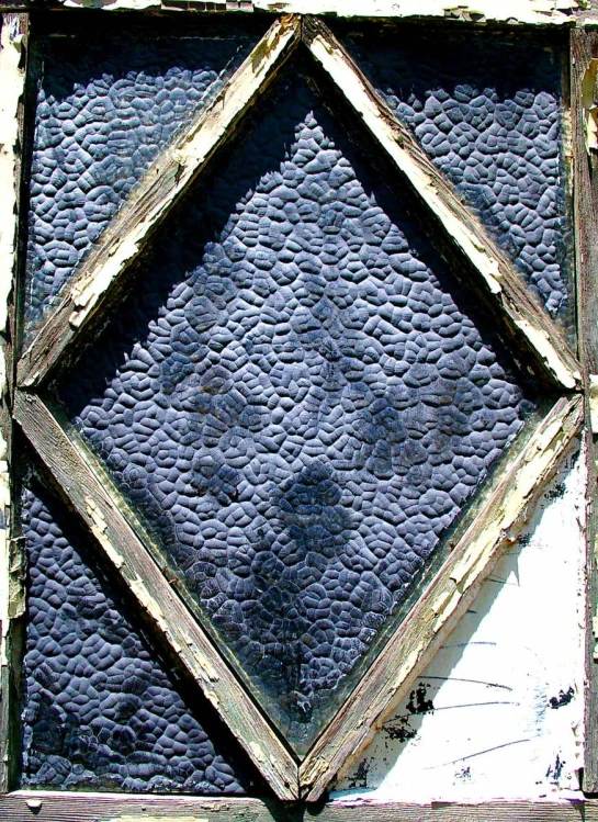 an old wooden window with diamond shapes