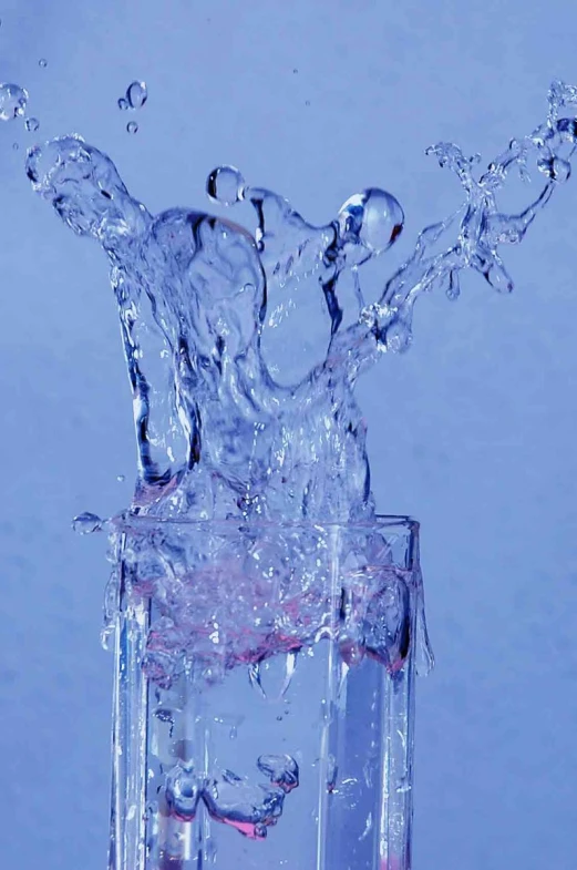 the water splash is in front of a glass