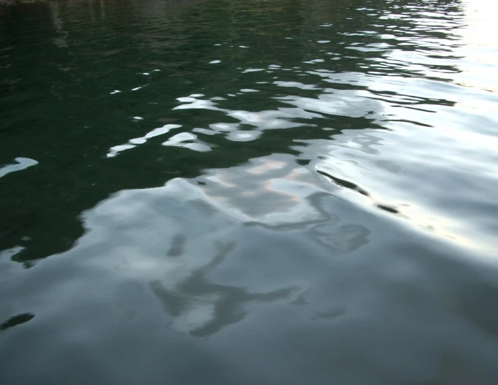 a boat in a body of water with its reflection in the water