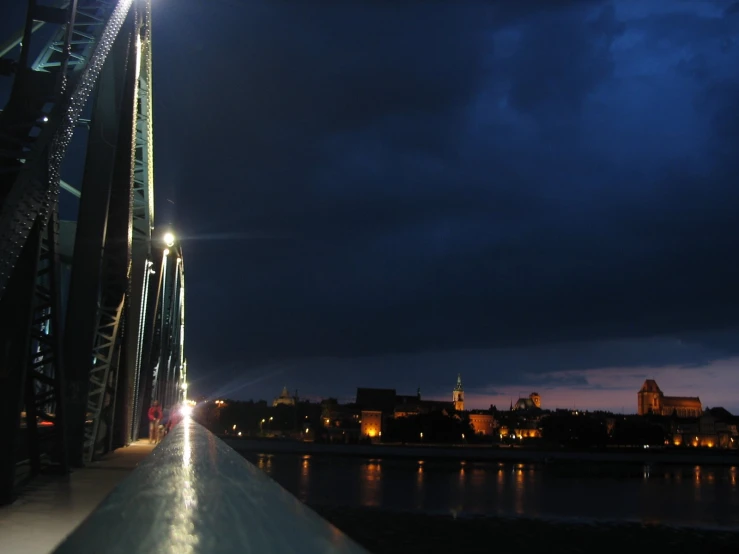 the lights are on above the water under a night sky