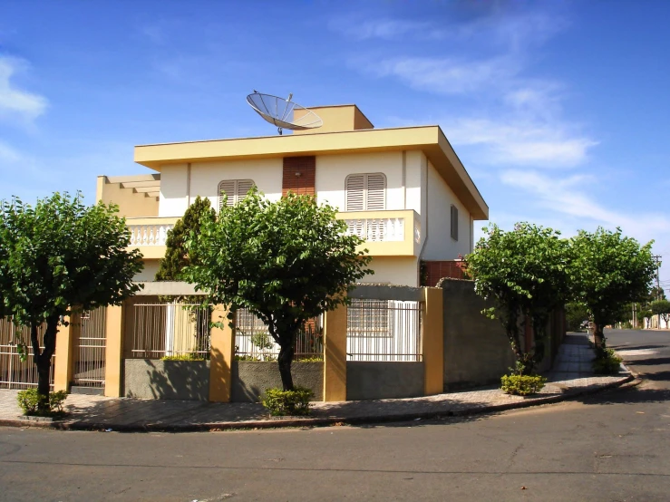 an intersection with a car approaching a very colorful house