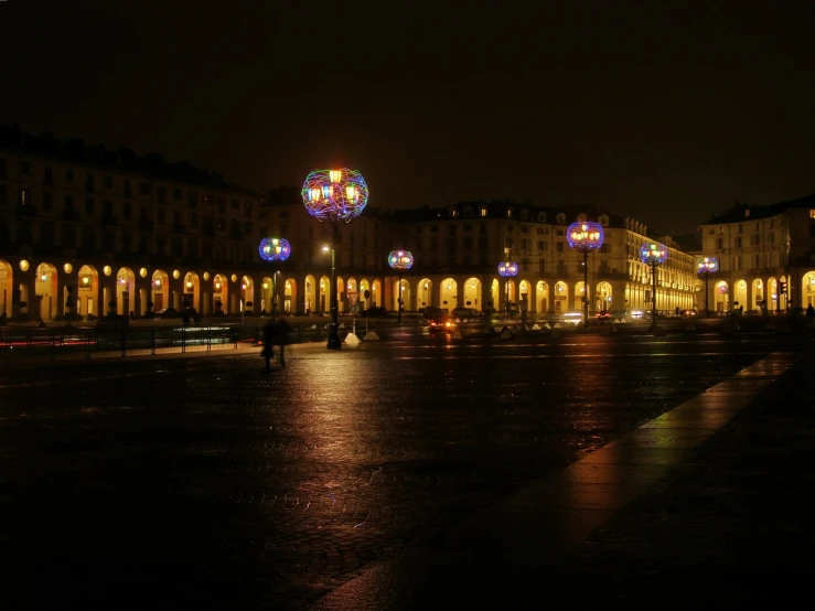 a city lit up at night with buildings and lights