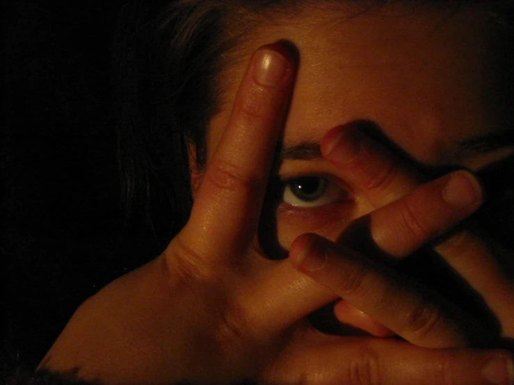 a woman's eyes can be seen through the reflection of the hand of her eye