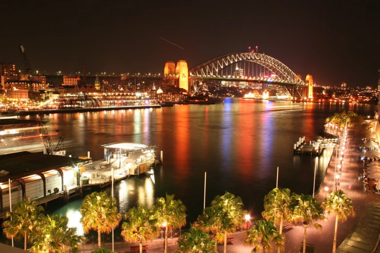 the city lights are on as the river boat pulls in