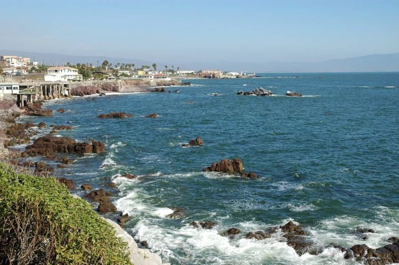 the shoreline of a beach where boats are anchored