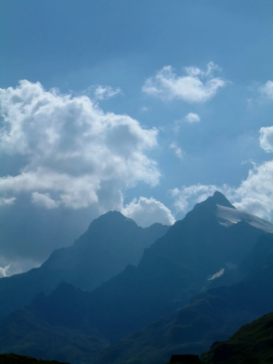 a mountain range has clouds in it