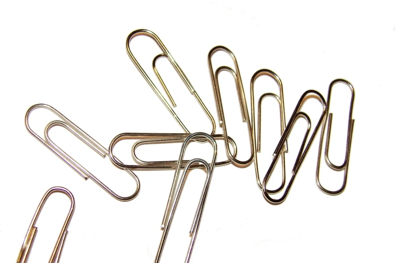 several metal paper clips arranged next to each other