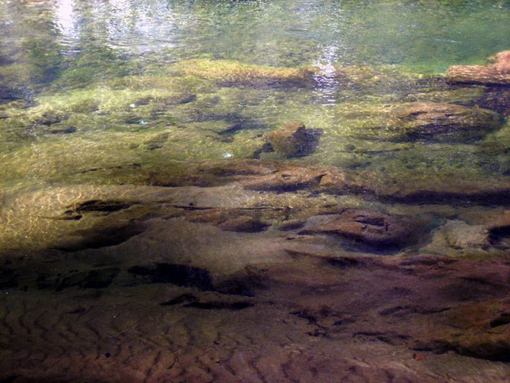 a po of some rocks and water with small waves