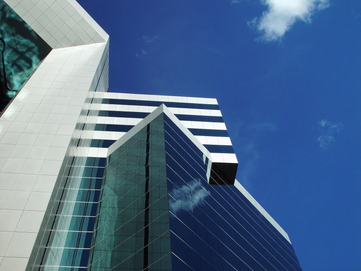 an image of a large glass skyscr on a clear day