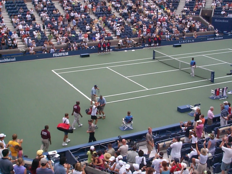 a large crowd is gathered at a tennis match