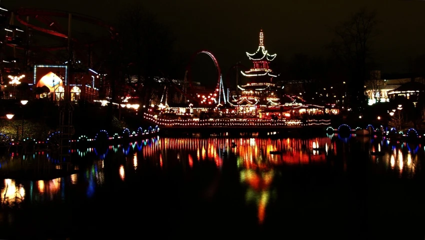 a dark, lit waterway at night with a reflection