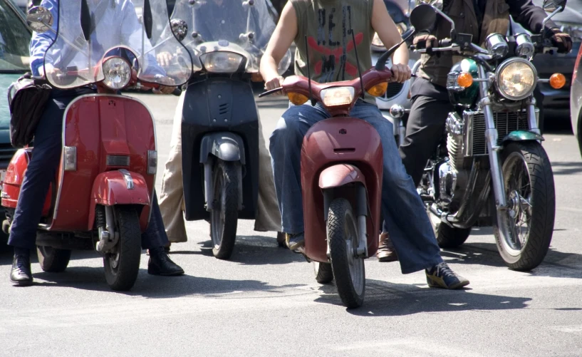 people are riding motorcycles on the street