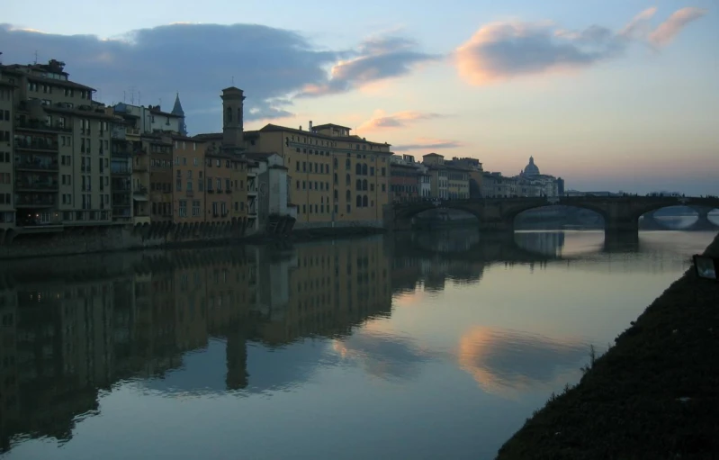 a small river is below several tall buildings