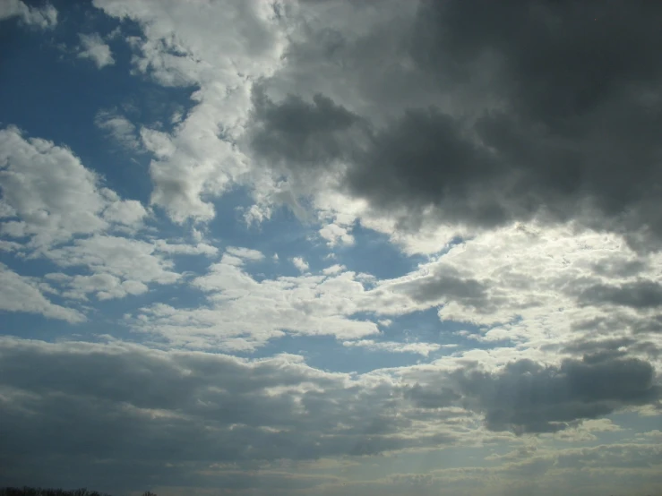 a group of planes flying in the sky under storm clouds