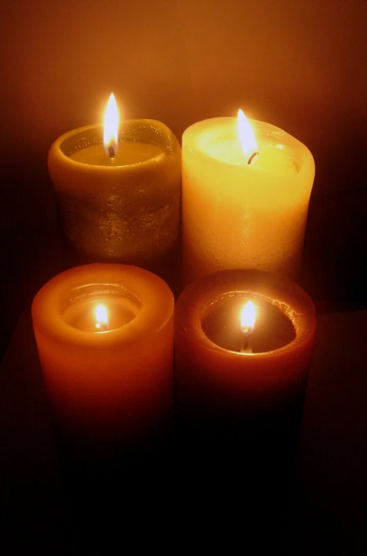 three lit candles are sitting next to each other