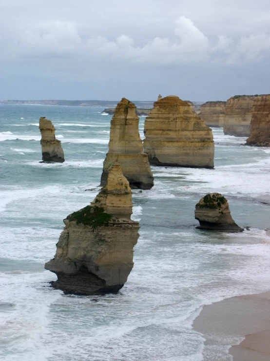 two very large rock formations sitting on top of the ocean