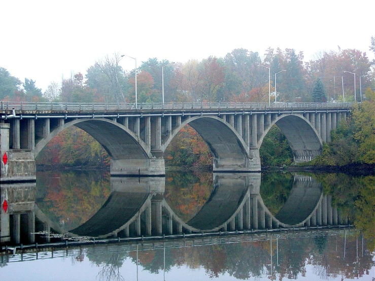 a bridge over a river with lots of water in front