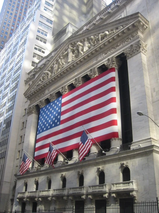 a building with american flags on it in the day