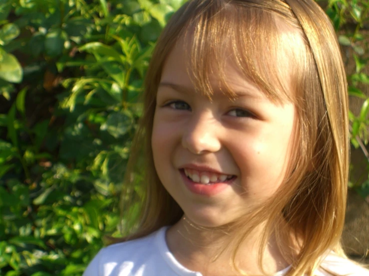 a little girl with an orange in her hand