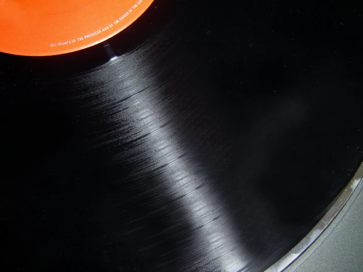 black record with orange label on table