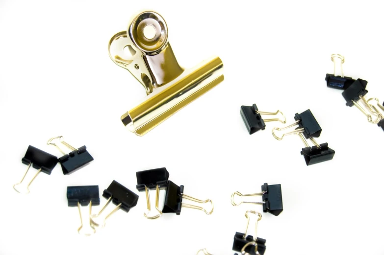 there are many small black and gold clip holders with white ones