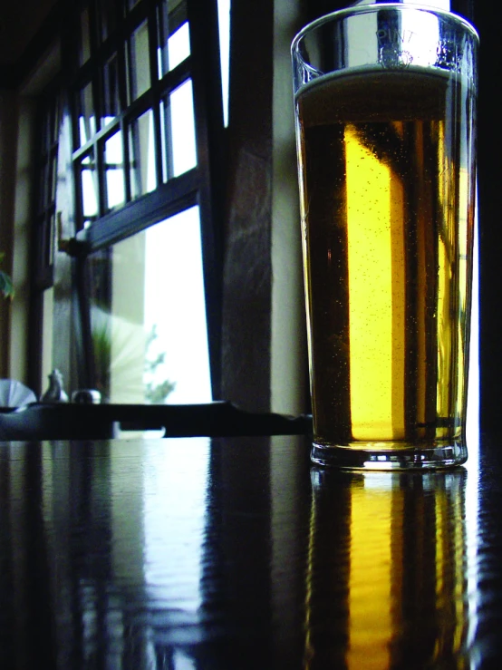 a close up of a beer glass with liquid in it