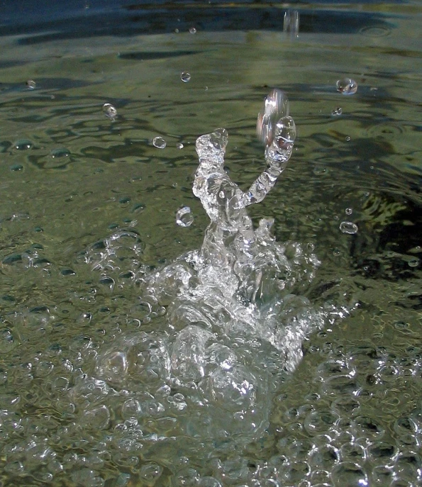 there are bubbles coming from water that has fallen to the water