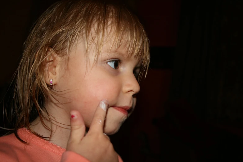 a little girl with her nose close to the ground