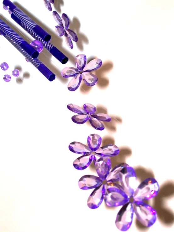 a close up of two pens with some flower shapes