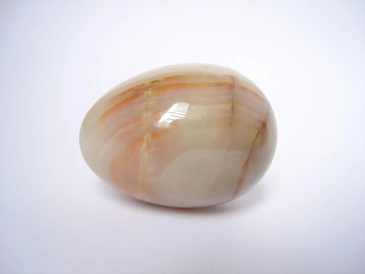 an oval piece of fruit sitting on top of a white surface