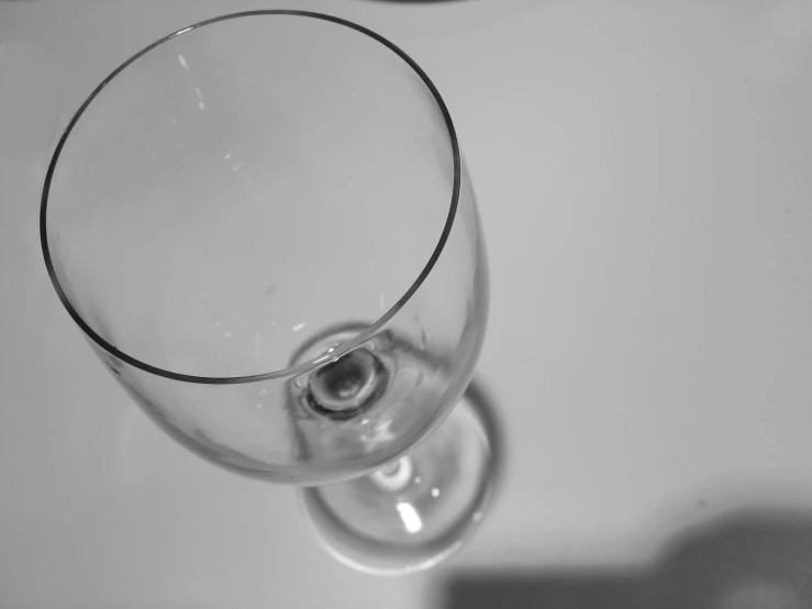 a clear glass of wine is sitting on the table