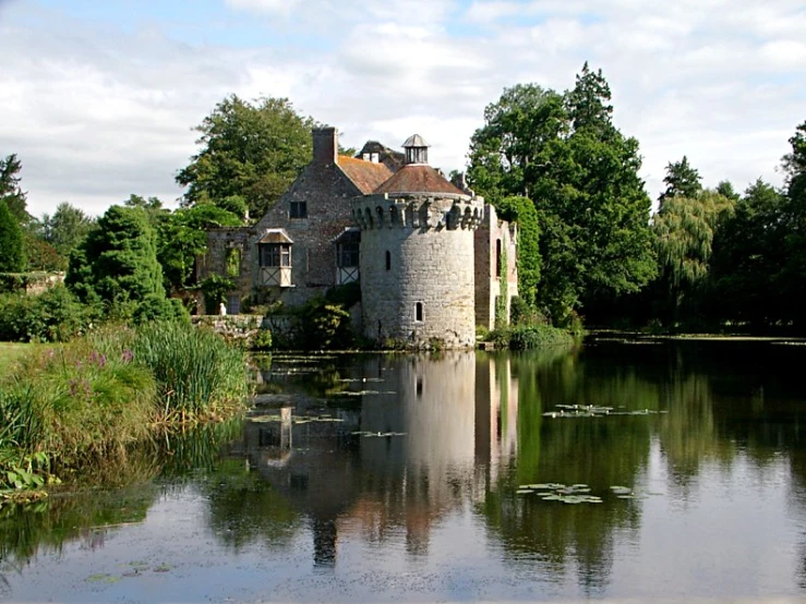 there is a castle with a pond in the foreground