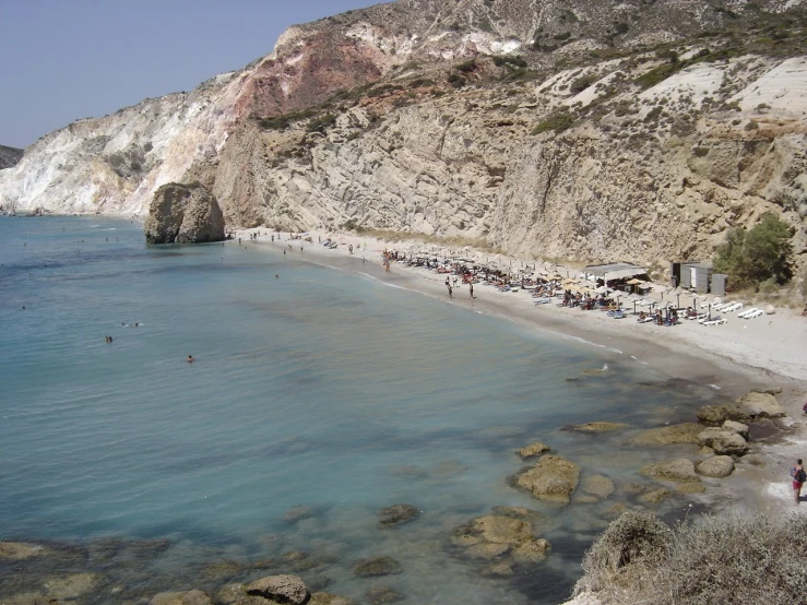 beach scene with people sunbathing and walking on sand