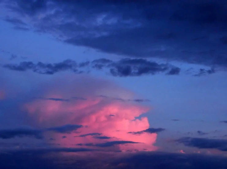 the sky at dusk showing bright pink clouds