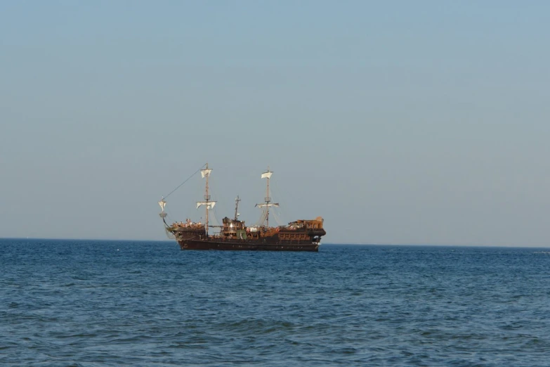 a boat in the ocean sailing on it's side