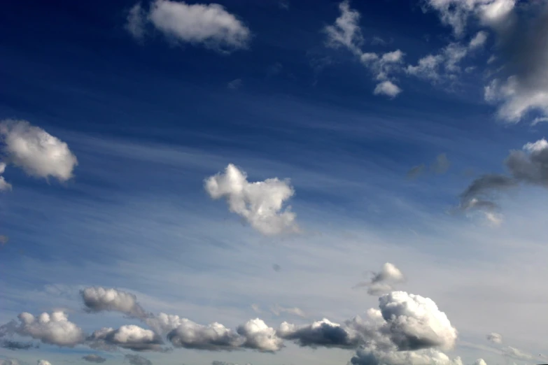 a cloudy sky that has white clouds above it