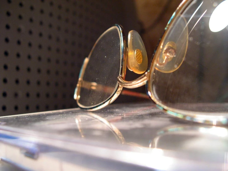 close up of two glasses one with metal rims