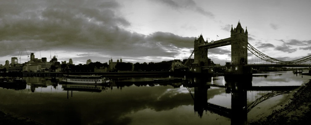 some large bridges on the water under a cloudy sky