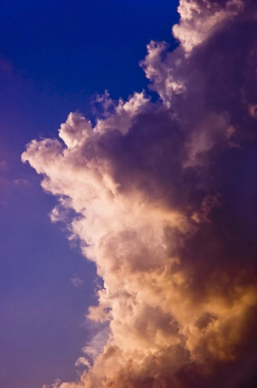 the dark clouds in the blue sky seem to be moving