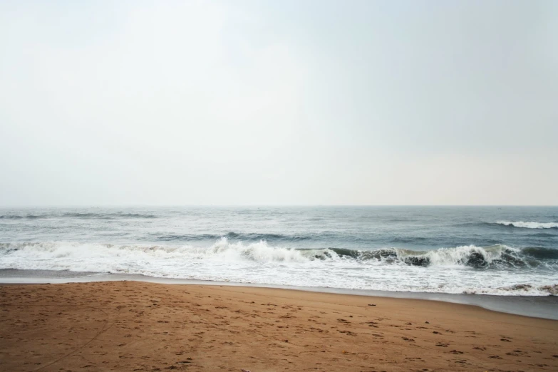 waves in the water coming onto a beach