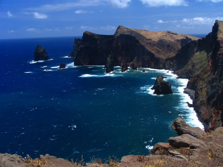 a body of water with many steep cliffs near the shore