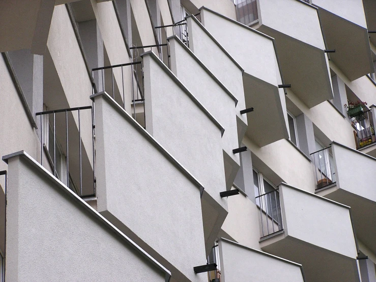 a white building with windows that has bars running up the side